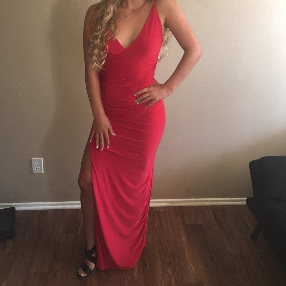 Long red prom dress with slit up the right side.